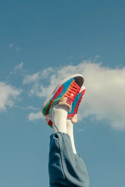 Lifestyle sneaker photography against blue sky backdrop