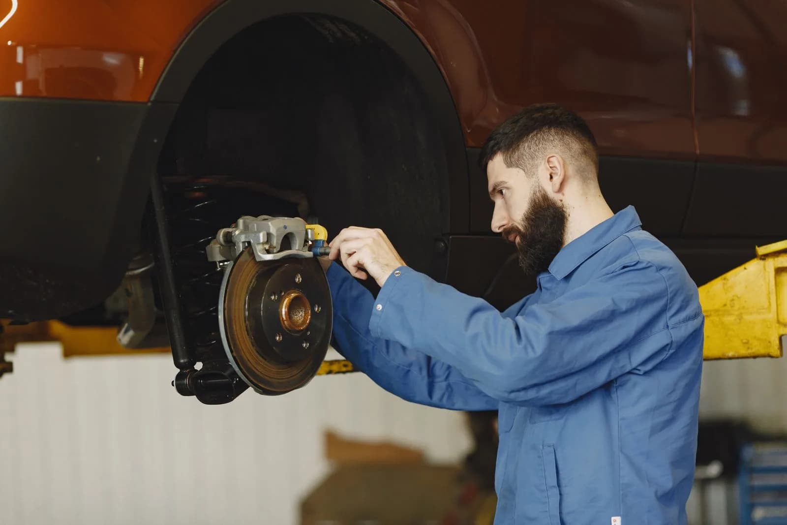 Technician replacing brakes — Auto Repair Shops & Mechanics marketing by TML Agency