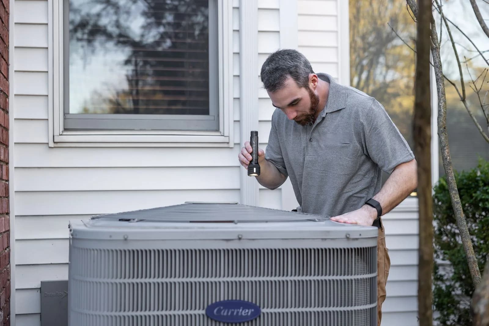 Hvac technician thermostat homeowner — HVAC Companies & Contractors marketing by TML Agency