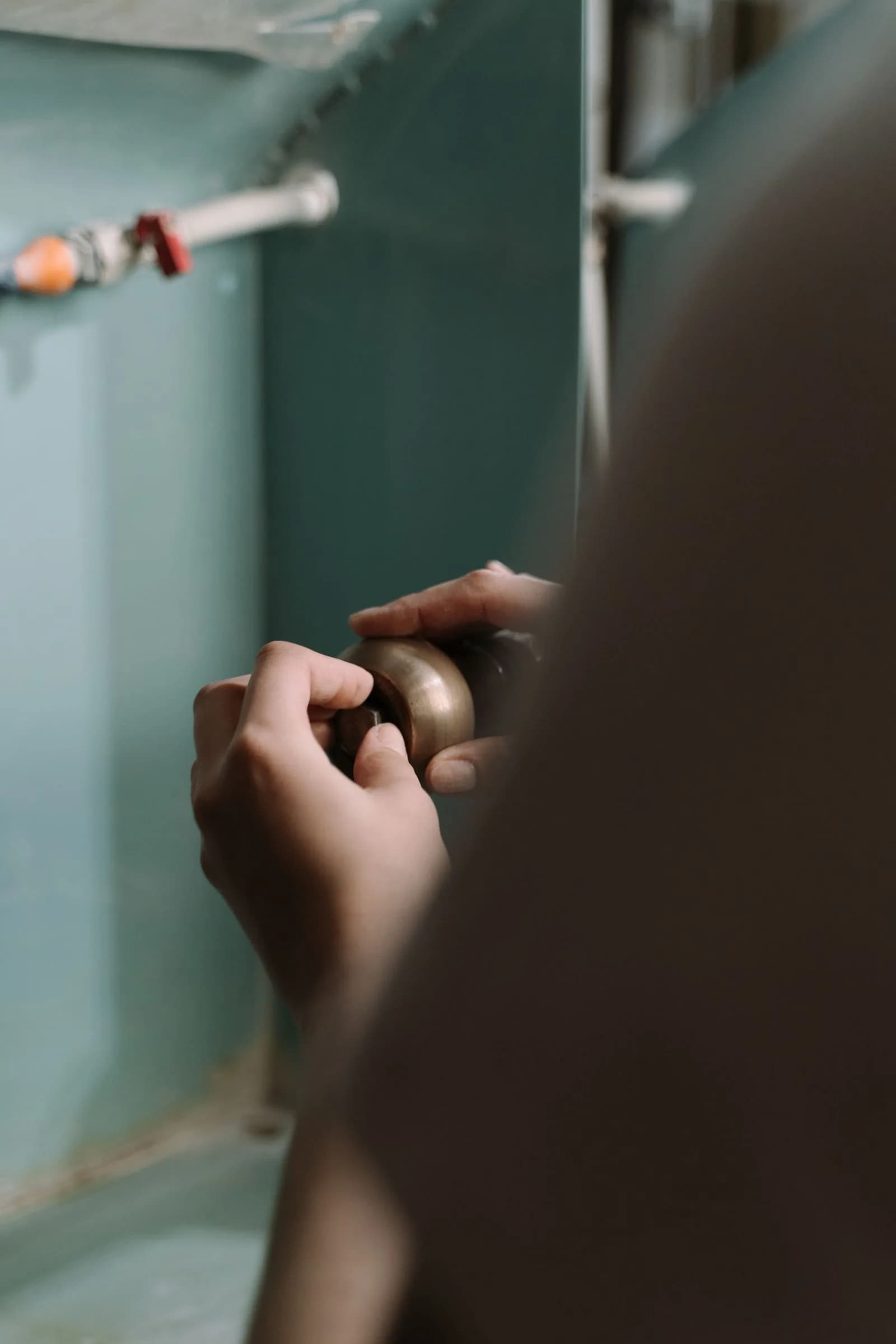 Plumber repairing sink leak — Plumbers marketing by TML Agency
